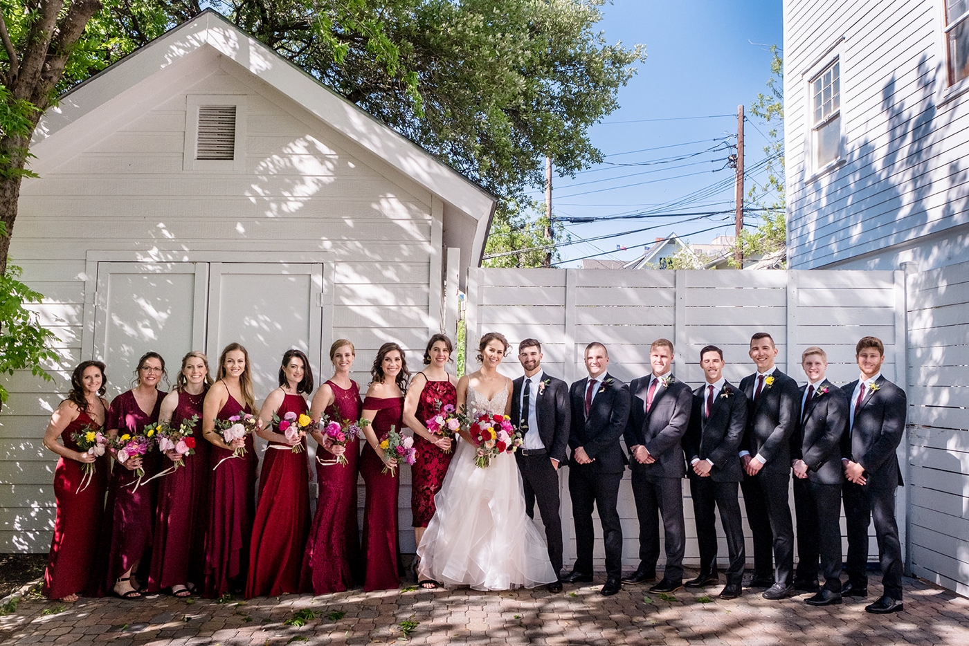 Burgundy bridesmaids dresses with colorful bouquets