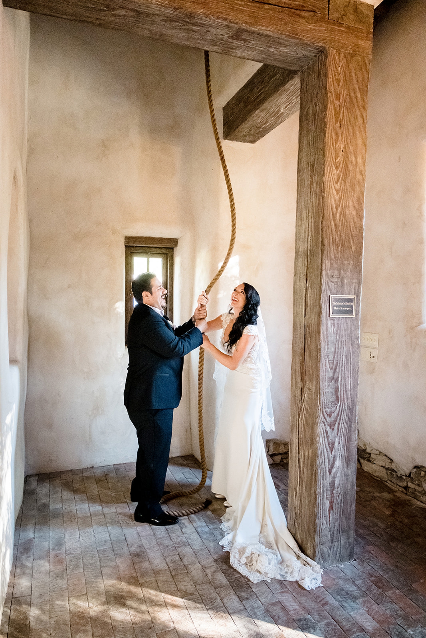Bride and groom ringing the bell at Lost Mission